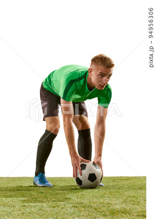 One young man, professional soccer football player training isolated on white studio background. Concept of action, energy, sport. 94956306
