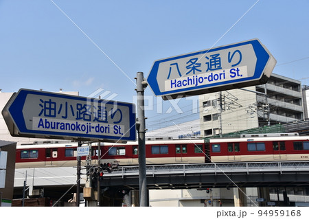 日本の京都府の京都市 京都駅周辺の街並み 通りの標識と高架式の線路を走る鉄道車両 日本の京都府の京都市 京都駅周辺の街並み 通りの標識と高架式の線路を走る鉄道車両 94959168