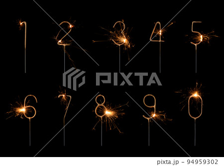 Golden sparklers in numbers digits shape set, burning bright with sparks, isolated on black Golden sparklers in numbers digits shape set, burning bright with sparks, isolated on black 94959302