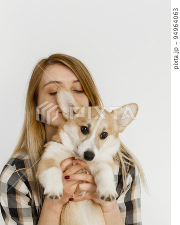 woman pet corgi dog plays teaches commands 94964063