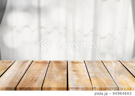 Empty of wooden table top on the blurry of the curtains around the window. For montage product display or design key visual layouts. 94964603