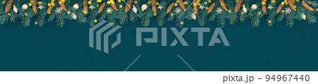 Merry Christmas and Happy New Year rich golden and crystal baubles festive ornaments garland. Lights and Christmas tree branches with cones on teal green. Party decor extra wide banner. 94967440