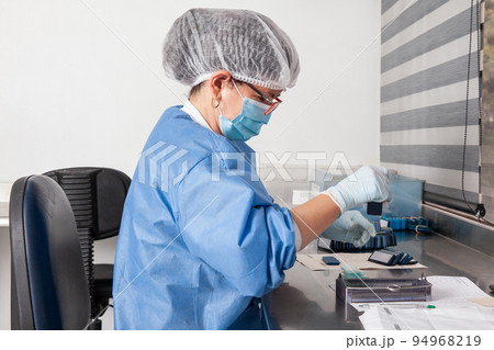 Laboratorian giving admission to pap smear samples in the laboratory for analysis. Scientist receiving patient samples for laboratory for analysis. Cervical cancer concept. Medical concept. Laboratorian giving admission to pap smear samples in the laboratory for analysis. Scientist receiving patient samples for laboratory for analysis. Cervical cancer concept. Medical concept. 94968219