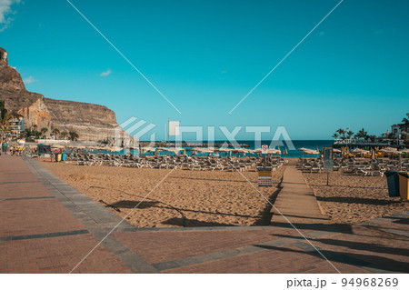 Beach in Canary Islands with rental loungers Beach in Canary Islands with rental loungers 94968269