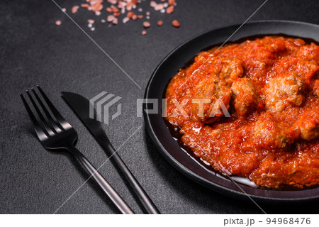 Delicious meatballs made from ground beef in a spicy tomato sauce Delicious meatballs made from ground beef in a spicy tomato sauce 94968476