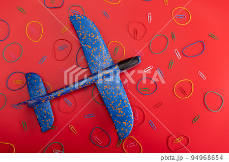 Toys and aircraft. Blue plane on a red background. Airplane and patterns. 94968654