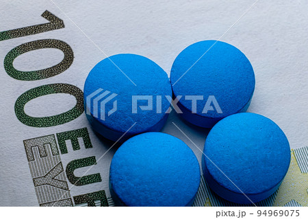 Healthcare. Blue tablets pill macro on 100 euro bill. Drug abuse Healthcare. Blue tablets pill macro on 100 euro bill. Drug abuse 94969075