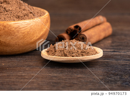 Selective focus on ground cinnamon on a wooden background. Selective focus on ground cinnamon on a wooden background. 94970173