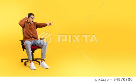 Shocked Man Pointing Finger Aside At Empty Space, Yellow Background Shocked Man Pointing Finger Aside At Empty Space, Yellow Background 94970306