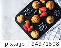 Blueberry and strawberry muffins with berries. Top view and copy space. 94971508