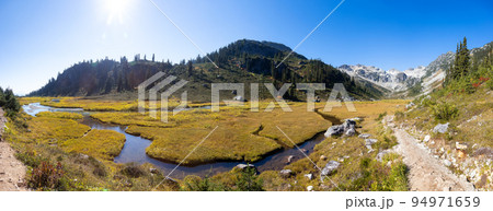 River, Trees and Peaks in Canadian Mountain Landscape. Sunny Fall Season. River, Trees and Peaks in Canadian Mountain Landscape. Sunny Fall Season. 94971659