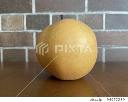 レンガの背景とテーブルの上に置かれた梨のアップ レンガの背景とテーブルの上に置かれた梨のアップ 94972289