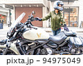 大型アメリカンバイクに乗って横浜元町ショッピングストリートに買い物に来た女性ライダー 94975049