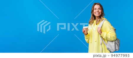 Lifestyle, college and people concept. Good-looking carefree blond woman going university look around happy and pleased smiling as drinking take-away coffee and holding backpack Lifestyle, college and people concept. Good-looking carefree blond woman going university look around happy and pleased smiling as drinking take-away coffee and holding backpack 94977993