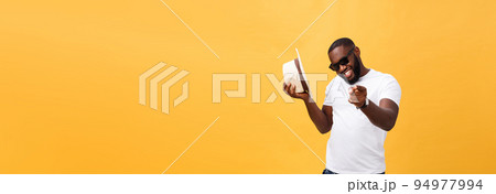 Young black man top dancing isolated on a yellow background. Young black man top dancing isolated on a yellow background. 94977994
