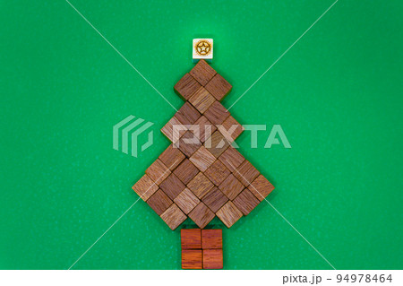 クリスマスを連想する頂上に星が輝く茶色の木のウッドキューブの背景 94978464