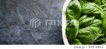 Fresh spinach leaves in a bowl, green vegetables, rustic style, healthy lifestyle, proper nutrition. Top view, space for text, banner Fresh spinach leaves in a bowl, green vegetables, rustic style, healthy lifestyle, proper nutrition. Top view, space for text, banner 94978843