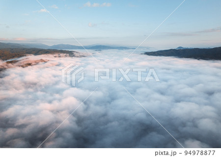 fog with mountains and light in the morning fog with mountains and light in the morning 94978877