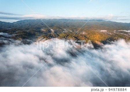 fog with mountains and light in the morning fog with mountains and light in the morning 94978884