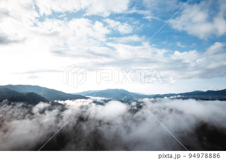 fog with mountains and light in the morning fog with mountains and light in the morning 94978886