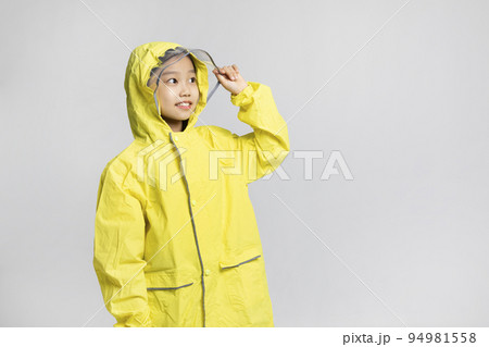 cute young Korean girl, rainy season concept in white background studio__wearing raincoat cute young Korean girl, rainy season concept in white background studio__wearing raincoat 94981558