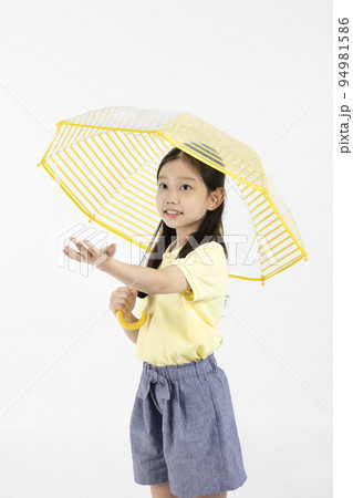 cute young Korean girl, rainy season concept in white background studio__holding an umbrella and reaching out out cute young Korean girl, rainy season concept in white background studio__holding an umbrella and reaching out out 94981586
