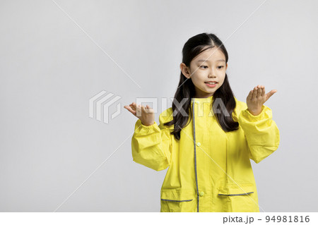 cute young Korean girl, rainy season concept in white background studio__raindrops falling in the raincoat cute young Korean girl, rainy season concept in white background studio__raindrops falling in the raincoat 94981816