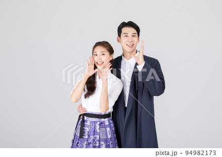 Korean young couple, man and woman wearing modern Hanbok_talking Korean young couple, man and woman wearing modern Hanbok_talking 94982173