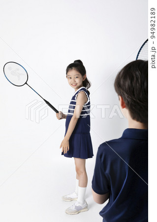 Korean boy and girl_fitness and exercise concept in white background__playing badminton with a friend 94982189