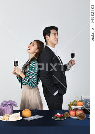 Korean young couple, man and woman wearing modern Hanbok_happy with holding wine glass 94982233
