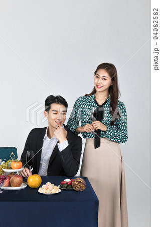Korean young couple, man and woman wearing modern Hanbok_holding a wine glass 94982582