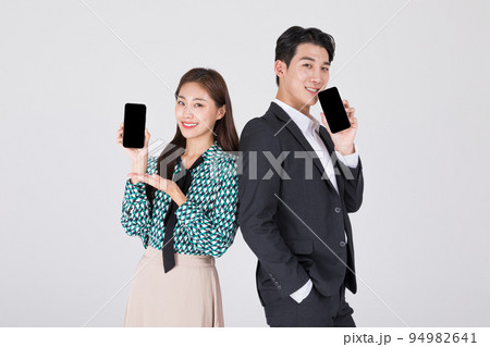Korean young couple, man and woman wearing modern Hanbok_holding smartphone Korean young couple, man and woman wearing modern Hanbok_holding smartphone 94982641