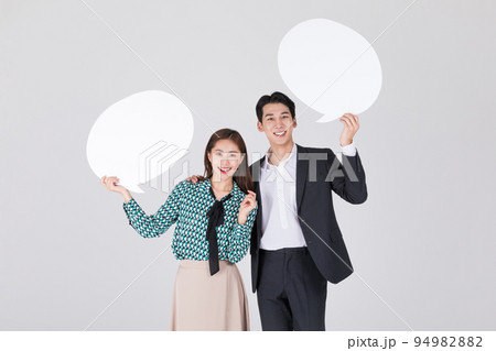 Korean young couple, man and woman wearing modern Hanbok_holidng speech bubble panel 94982882