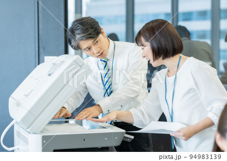 オフィスで立ち話をする男女 94983139