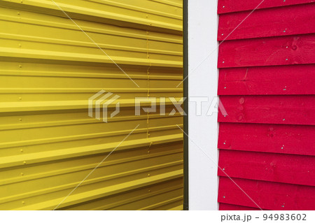 Close-up of yellow and red building walls 94983602