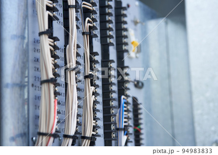 The wires are connected to the residual current circuit breakers and voltage monitoring relays. Electric control panel. High quality photo The wires are connected to the residual current circuit breakers and voltage monitoring relays. Electric control panel. High quality photo 94983833