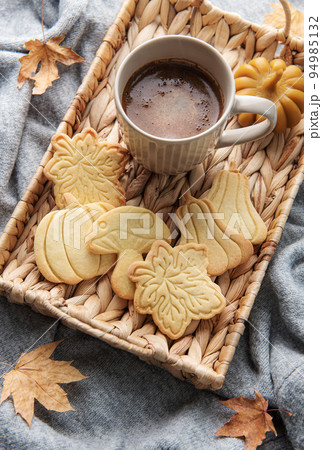 Cup of coffee, cookies on tray, yellow leaves. Cup of coffee, cookies on tray, yellow leaves. 94985132