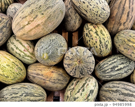 stack of fresh melons on wooden in market. Top view stack of fresh melons on wooden in market. Top view 94985998