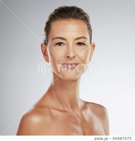 Senior woman with botox, portrait of skincare dermatology beauty and cosmetics spa portrait in Portugal. Happy confident lady, sunscreen wellness with microblading eyebrow makeup and gray background 94987075