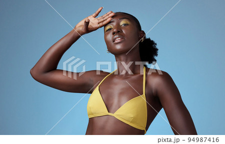 Black beauty, yellow bikini and an African woman on blue background, sexy in yellow. Bright makeup, dark skin and a beautiful girl. Skincare, colorful cosmetics and a portrait of lady from Africa. Black beauty, yellow bikini and an African woman on blue background, sexy in yellow. Bright makeup, dark skin and a beautiful girl. Skincare, colorful cosmetics and a portrait of lady from Africa. 94987416