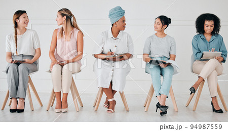 Diversity, interview and business people in waiting room at a job, hiring or recruitment center. Corporate, women and professionals talking with technology in a unemployment office for a work vacancy 94987559