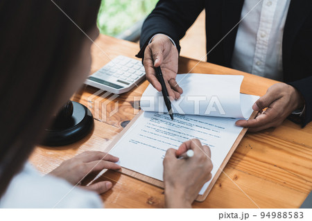 Real estate broker agent presenting and consult to customer to decision making sign insurance form agreement, home model, concerning mortgage loan offer in office. Real estate broker agent presenting and consult to customer to decision making sign insurance form agreement, home model, concerning mortgage loan offer in office. 94988583
