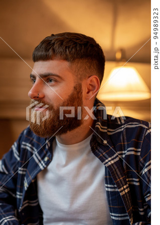 Portrait handsome bearded man wearing plaid shirt at modern cafe. Portrait handsome bearded man wearing plaid shirt at modern cafe. 94989323