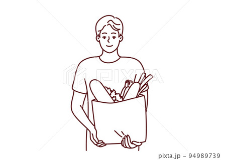 Smiling man holding bag with groceries  94989739