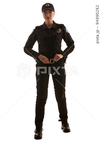 Full length shot of a redheaded female police officer posing for the camera isolated on white background. 94990262