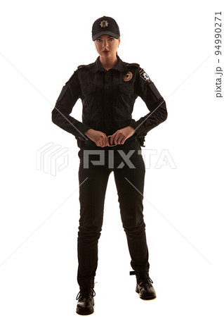 Full length shot of a redheaded female police officer posing for the camera isolated on white background. Full length shot of a redheaded female police officer posing for the camera isolated on white background. 94990271