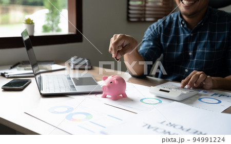 Happy man hand putting money coin into piggy for saving money wealth and financial accounting concept Happy man hand putting money coin into piggy for saving money wealth and financial accounting concept 94991224