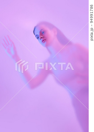 Mystical portrait of young tender girl immersed in clouds of smoke, fog on pink neon background with backlight diffuser. Art, creativity, futurism Mystical portrait of young tender girl immersed in clouds of smoke, fog on pink neon background with backlight diffuser. Art, creativity, futurism 94991786