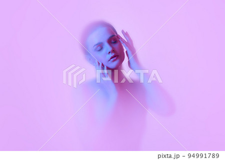 Mystical portrait of young tender girl immersed in clouds of smoke, fog on pink neon background with backlight diffuser. Art, creativity, futurism Mystical portrait of young tender girl immersed in clouds of smoke, fog on pink neon background with backlight diffuser. Art, creativity, futurism 94991789