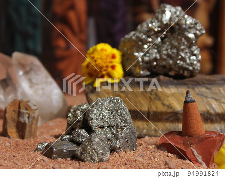 Yellow Flower With Pyrite Rocks and Crystals on Australian Red Sand Yellow Flower With Pyrite Rocks and Crystals on Australian Red Sand 94991824
